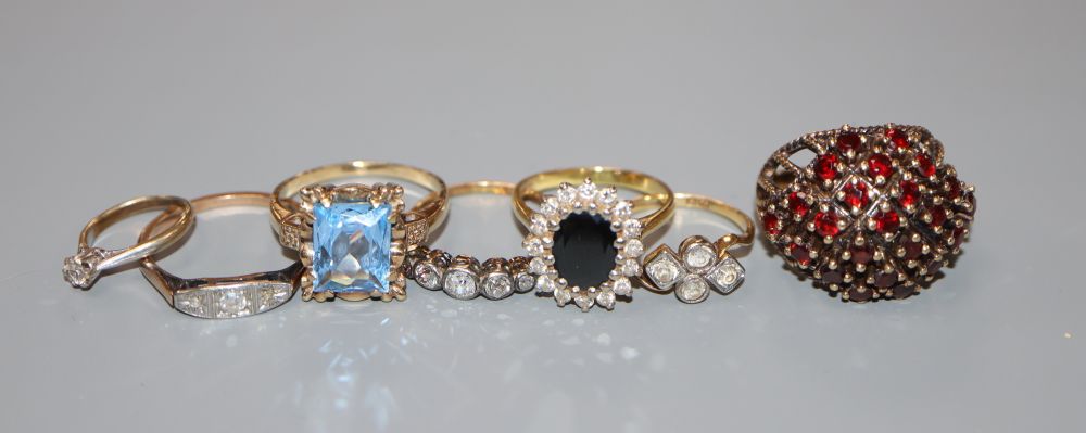 Seven assorted gem set rings .